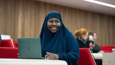 Education, Childhood and Professional Studies student in lecture with laptop