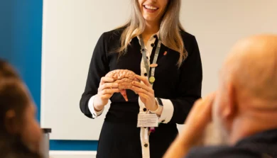 Psychology lecturer in classroom talking to students