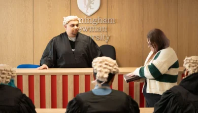 Courtroom setting with judges and person in witness stand