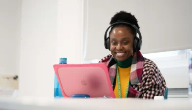 Student using laptop with headphones on